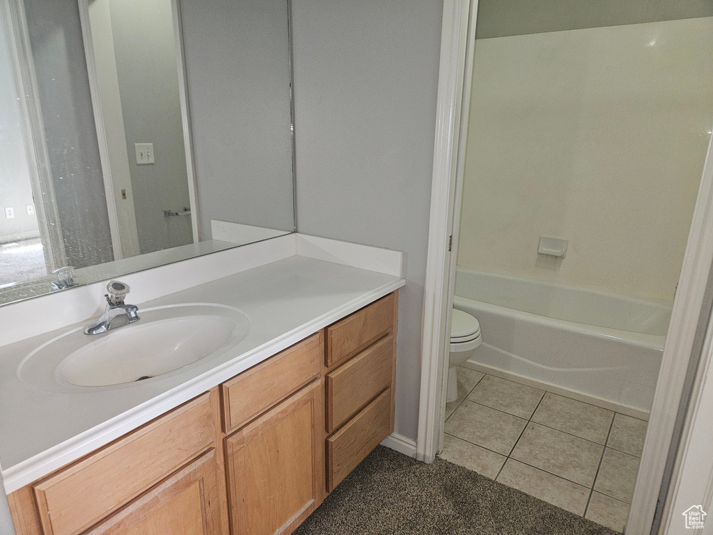 Bathroom with vanity, tile patterned flooring, and toilet