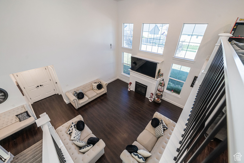 Living room featuring hardwood / wood-style flooring and a towering ceiling