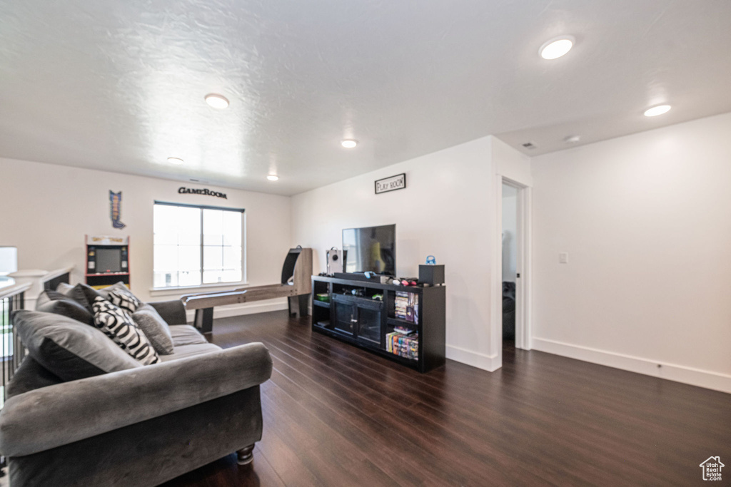 Living room with dark hardwood / wood-style flooring