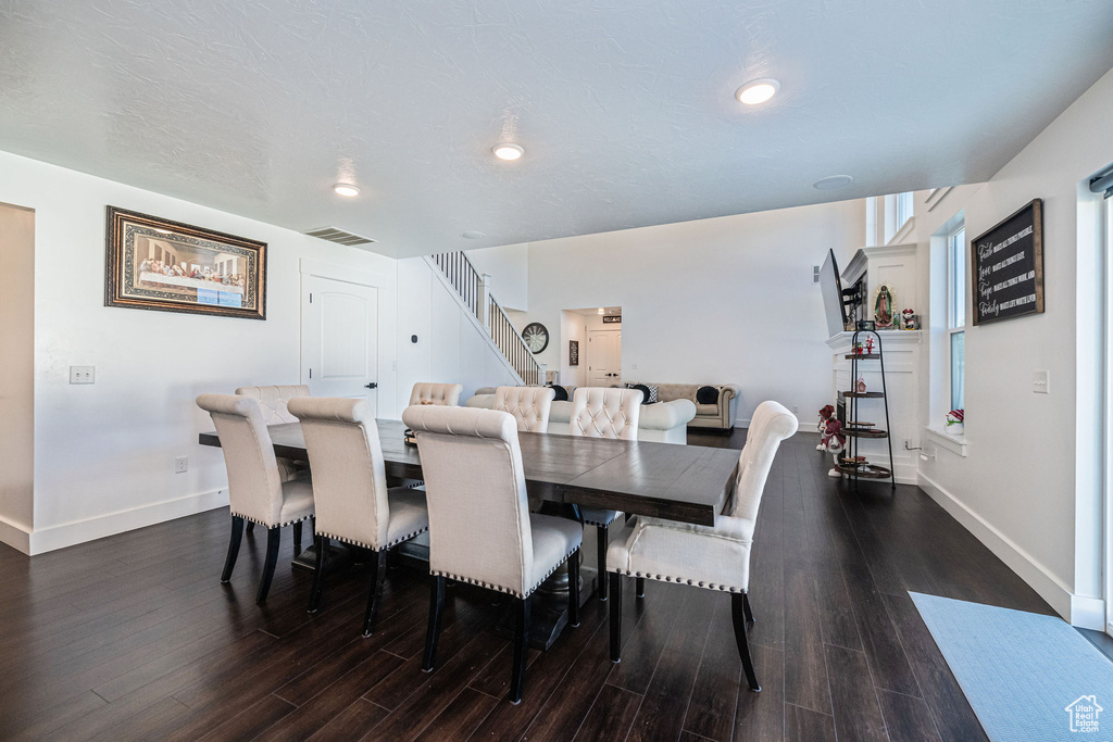 Dining area with dark wood-type flooring