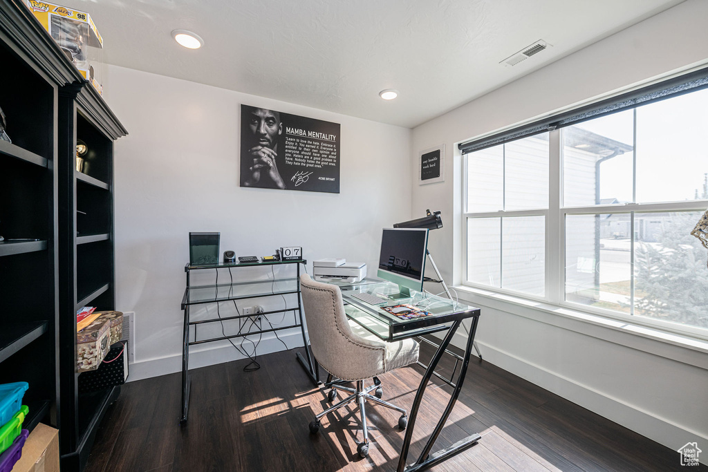 Home office featuring dark wood-type flooring