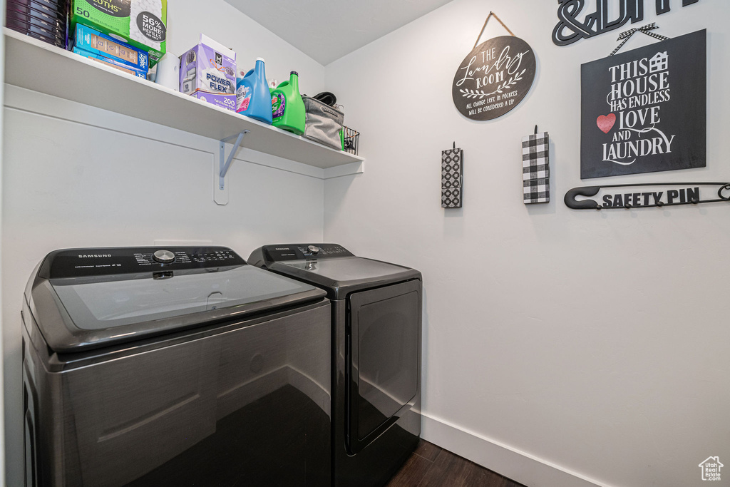 Washroom featuring dark hardwood / wood-style floors and separate washer and dryer