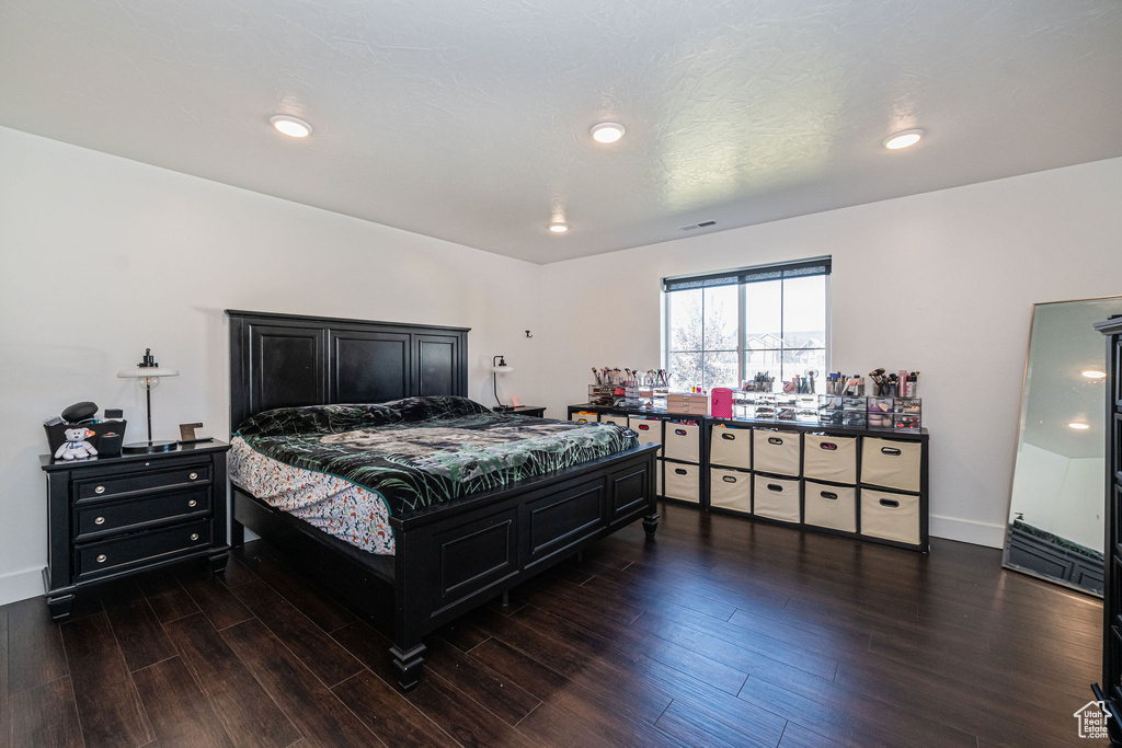 Bedroom with dark wood-type flooring