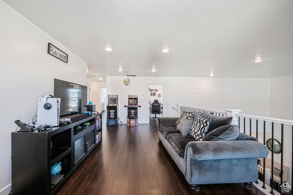 Living room with dark hardwood / wood-style flooring