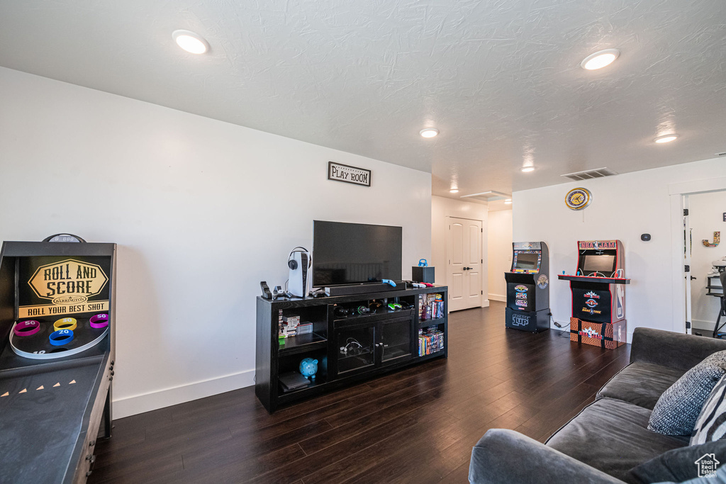 Living room with dark hardwood / wood-style flooring