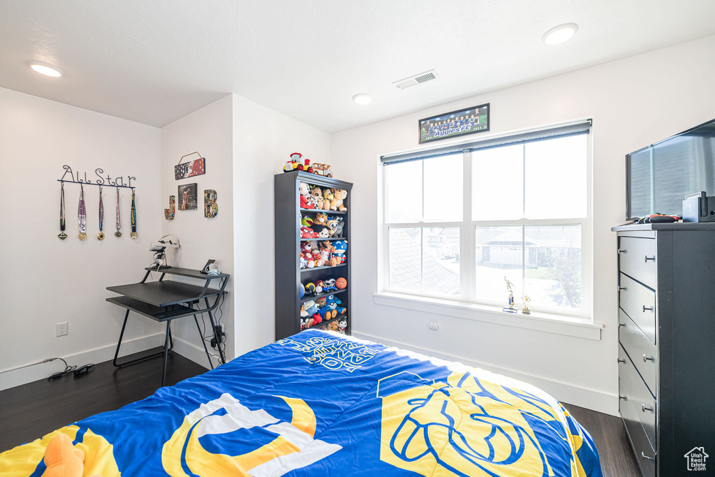 Bedroom with dark wood-type flooring