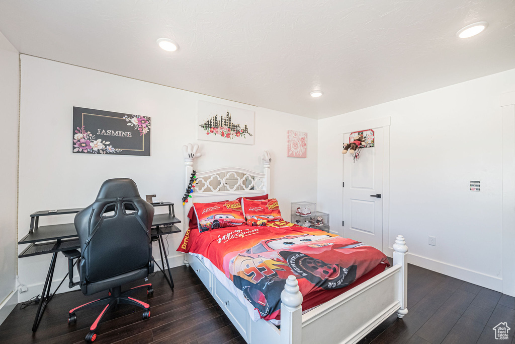 Bedroom with dark hardwood / wood-style floors