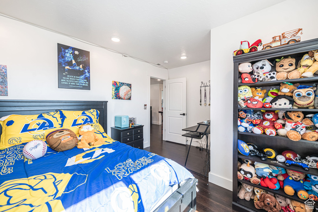 Bedroom with dark wood-type flooring