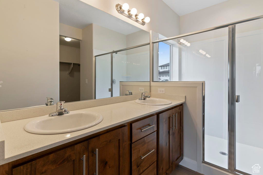 Bathroom with vanity and a shower with shower door