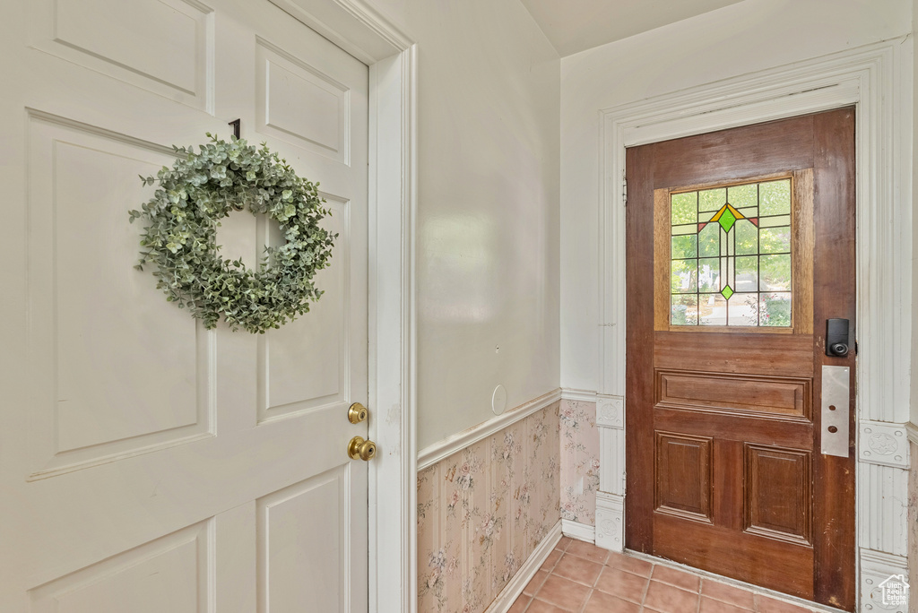 Doorway to outside featuring light tile patterned floors