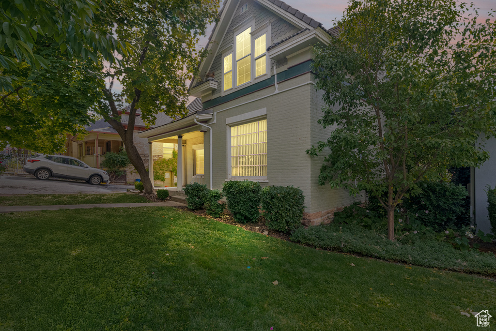 View of front facade featuring a yard