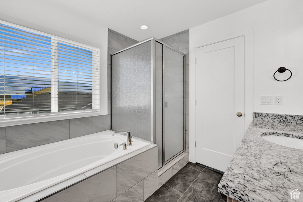 Bathroom featuring vanity and plus walk in shower