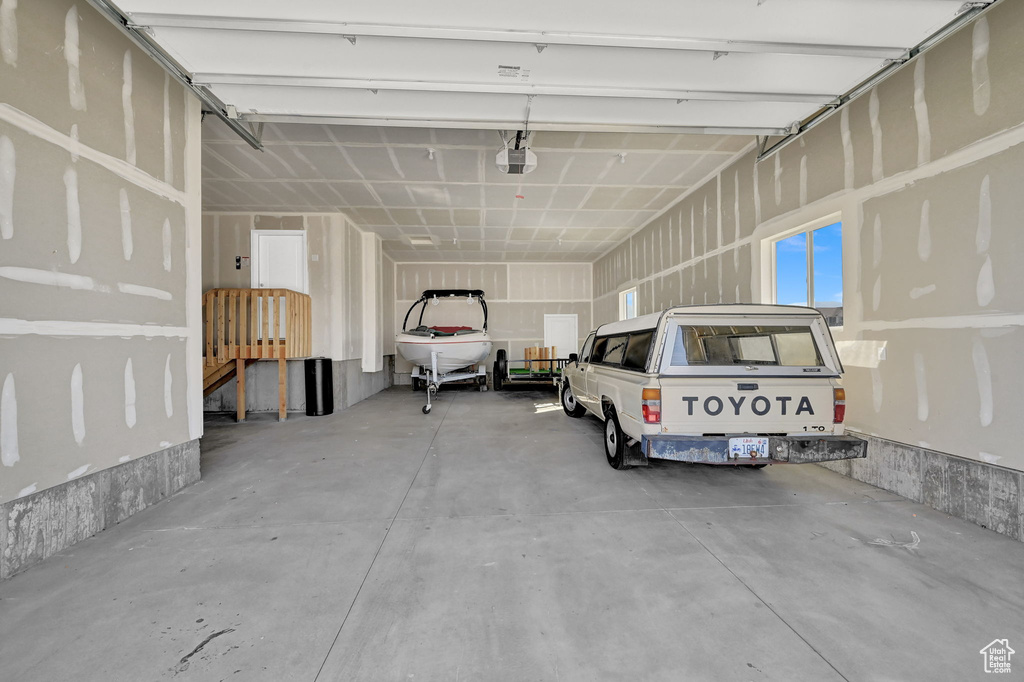 Garage featuring a garage door opener and sink