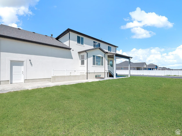 Back of property with a patio area and a yard