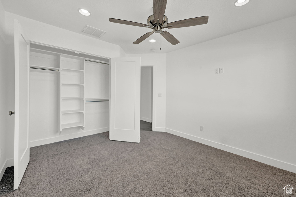 Unfurnished bedroom with carpet flooring, ceiling fan, and a closet