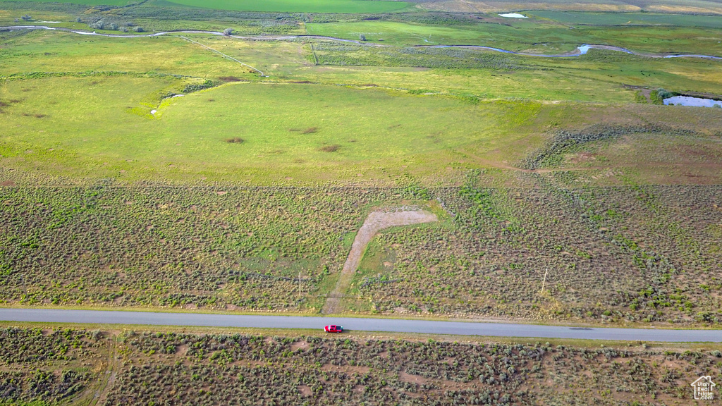 Aerial view featuring a water view and a rural view
