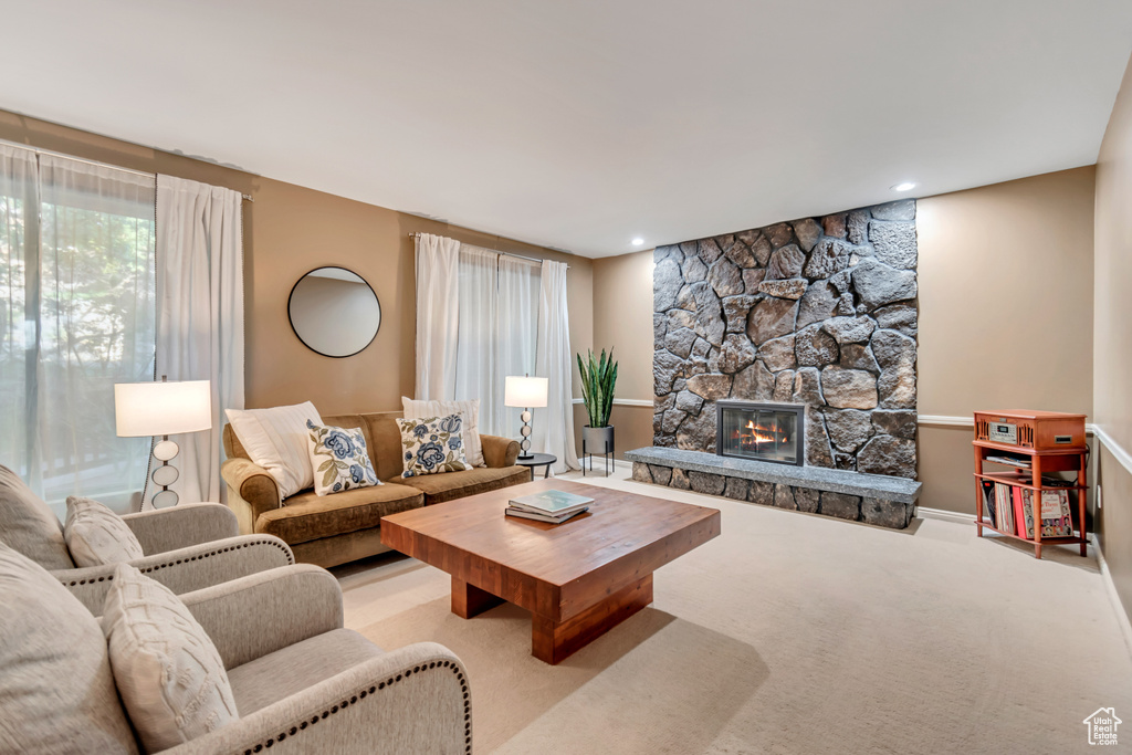 Living room with light colored carpet and a fireplace