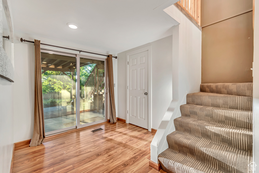 Foyer entrance with light hardwood / wood-style floors