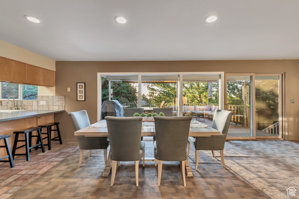 Dining space featuring a healthy amount of sunlight and sink