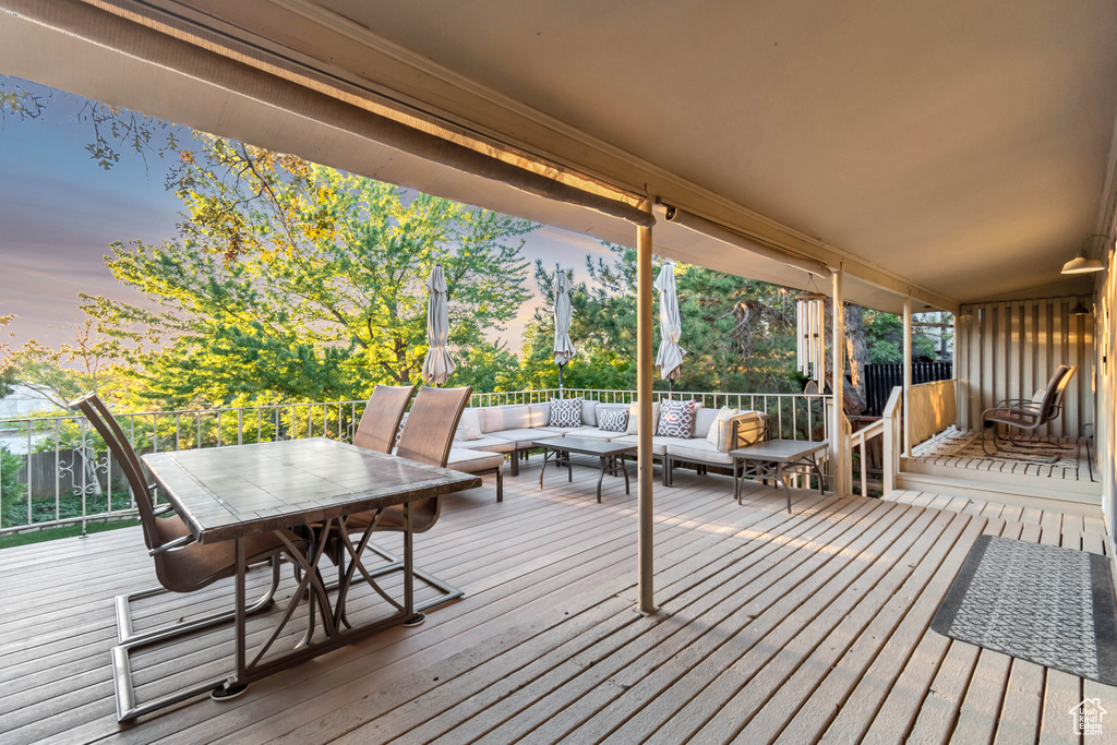 Deck at dusk with an outdoor living space