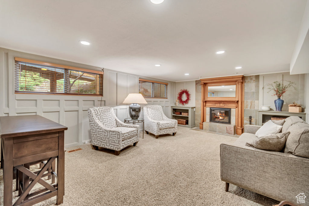 Living room with a tile fireplace and carpet flooring