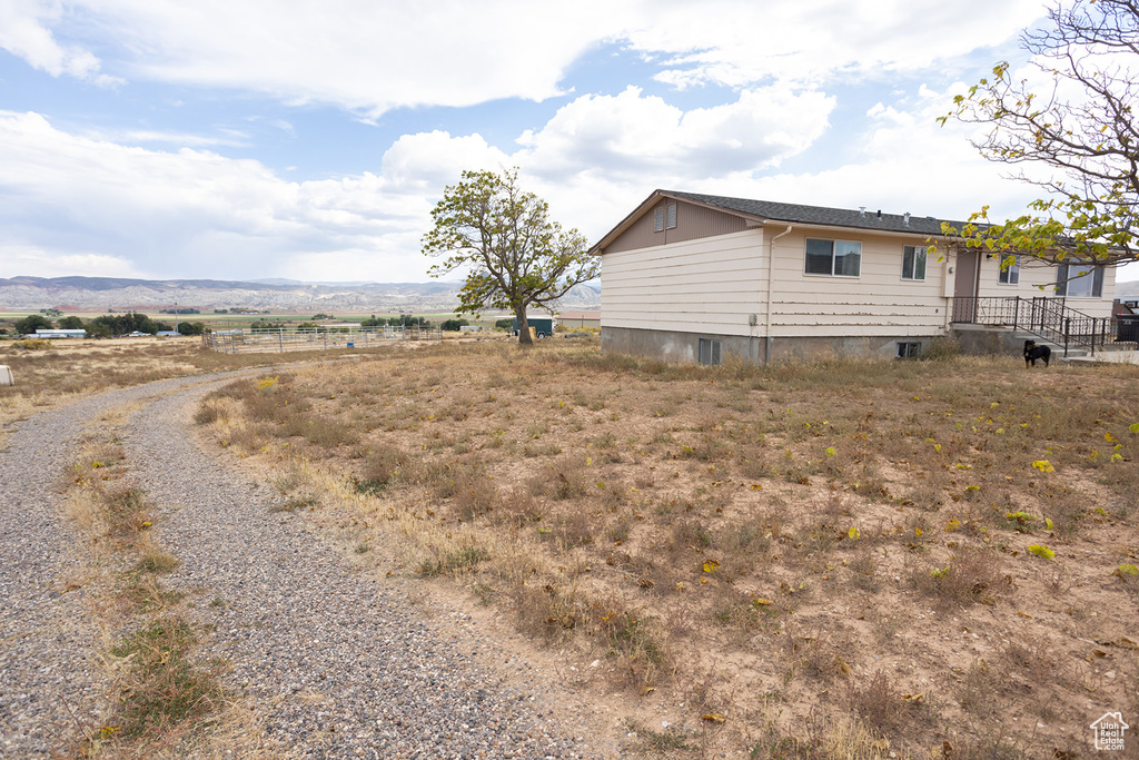 View of property exterior featuring a mountain view