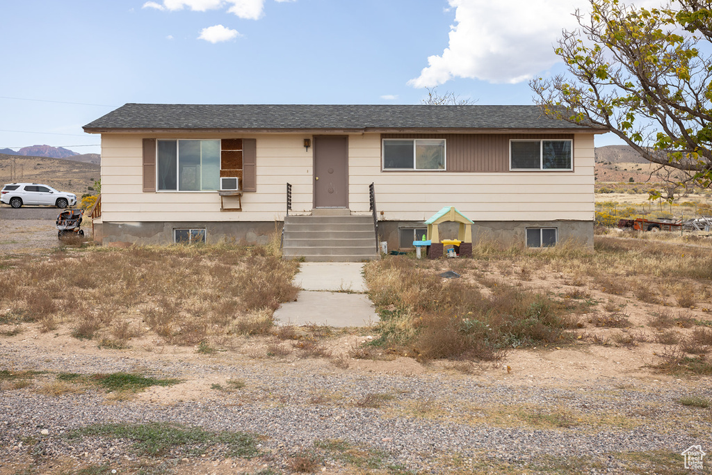 View of front of property featuring cooling unit and a mountain view