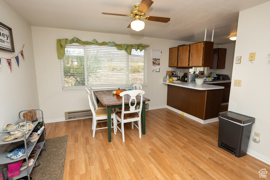 Dining space featuring ceiling fan and light hardwood / wood-style floors