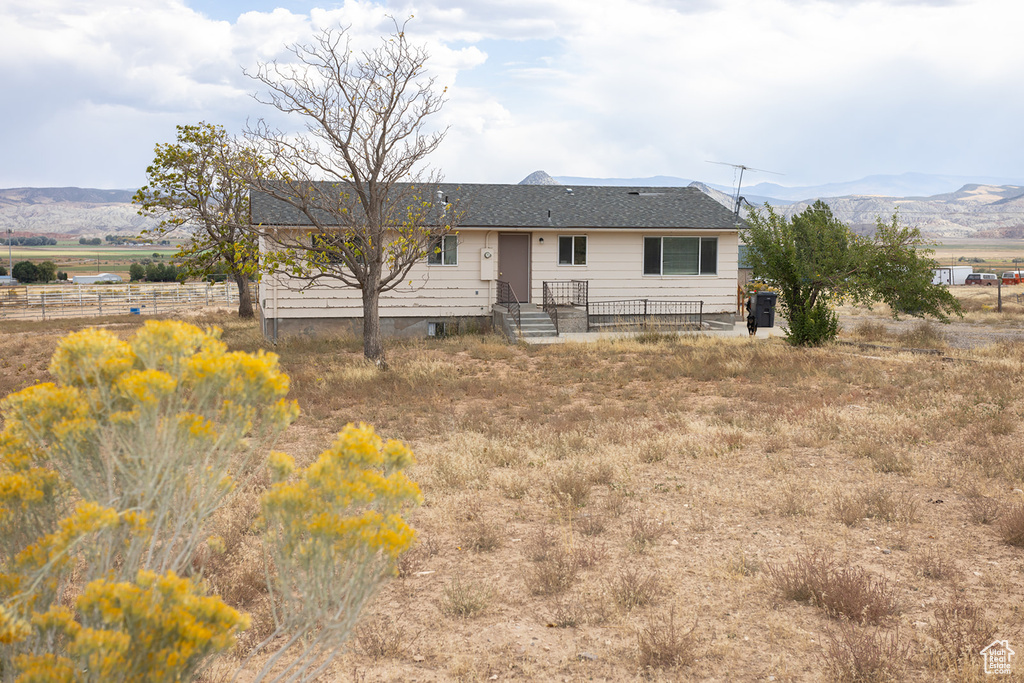 Rear view of house featuring a mountain view