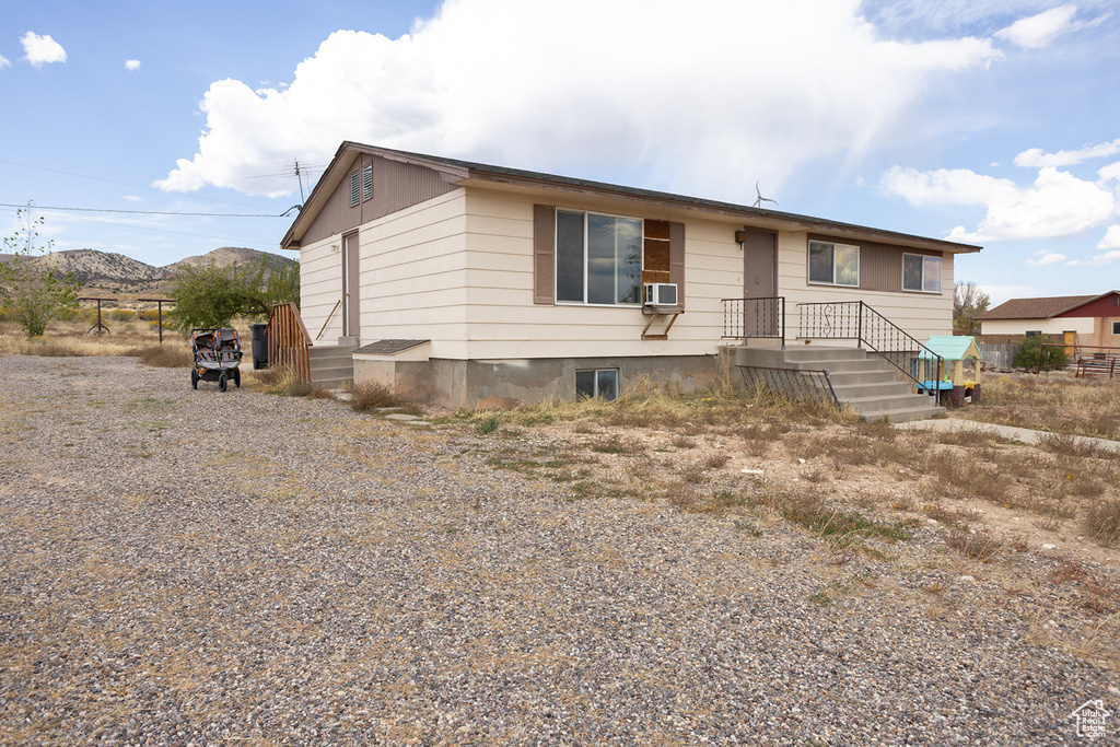 View of front of home featuring cooling unit and a mountain view