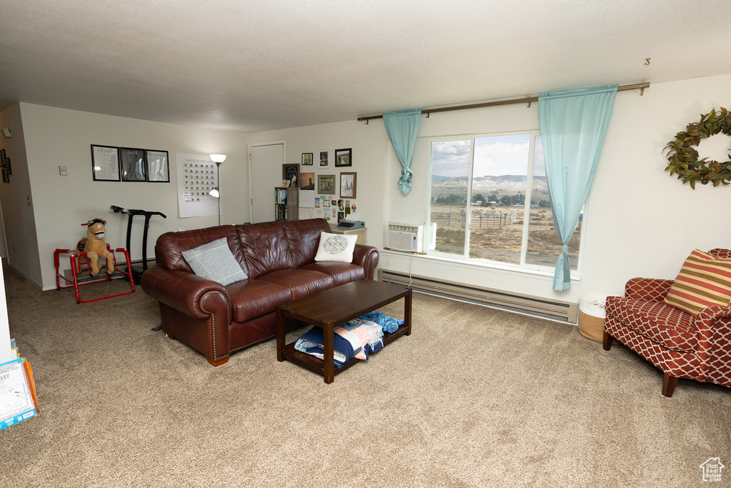 Carpeted living room with baseboard heating