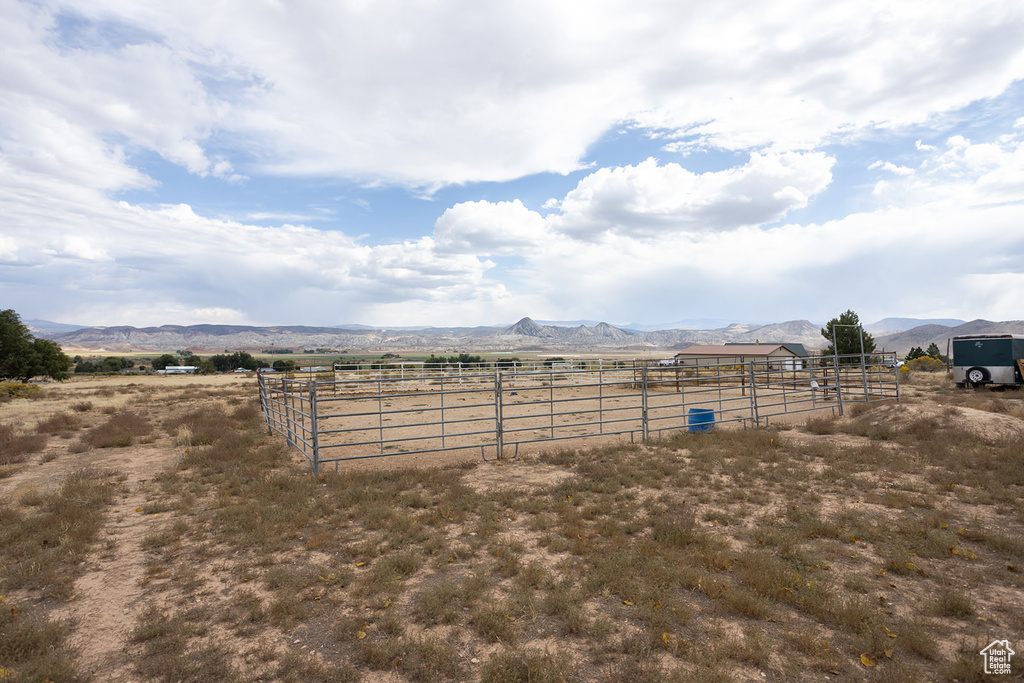 View of yard with a rural view and a mountain view