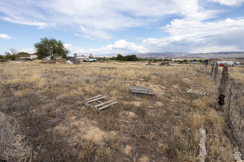 View of yard featuring a rural view and a mountain view