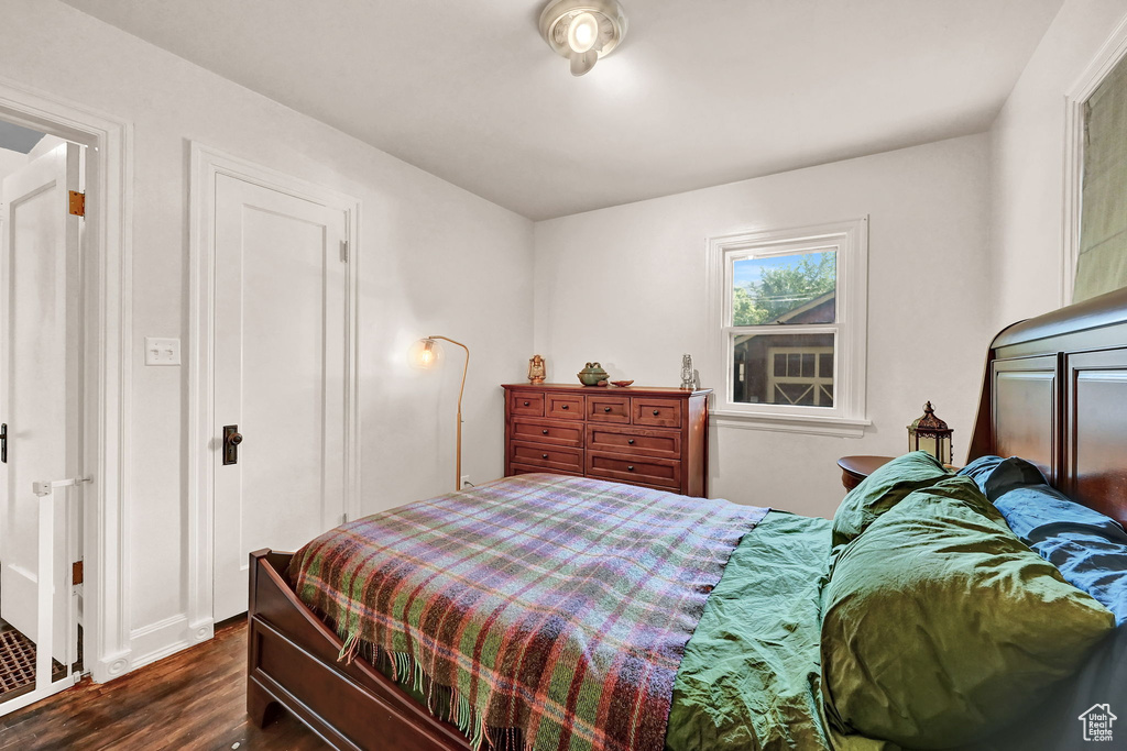 Bedroom with dark wood-type flooring