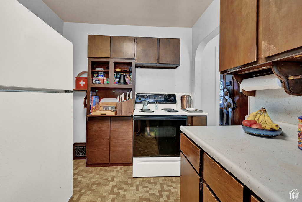 Kitchen featuring white appliances and exhaust hood