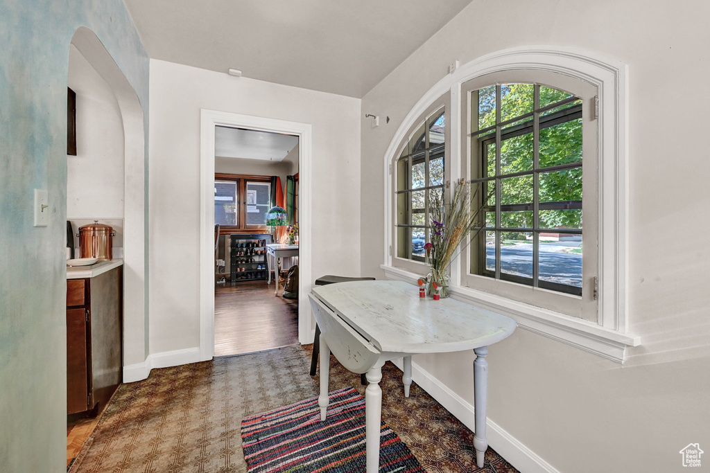 Dining room with dark hardwood / wood-style flooring