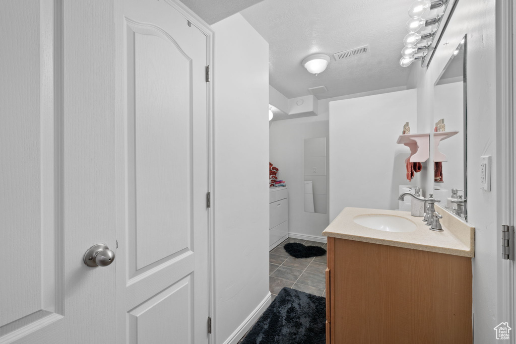 Bathroom with tile patterned flooring and vanity