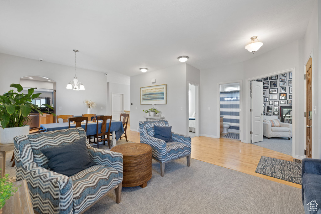 Living room featuring a notable chandelier and hardwood / wood-style flooring