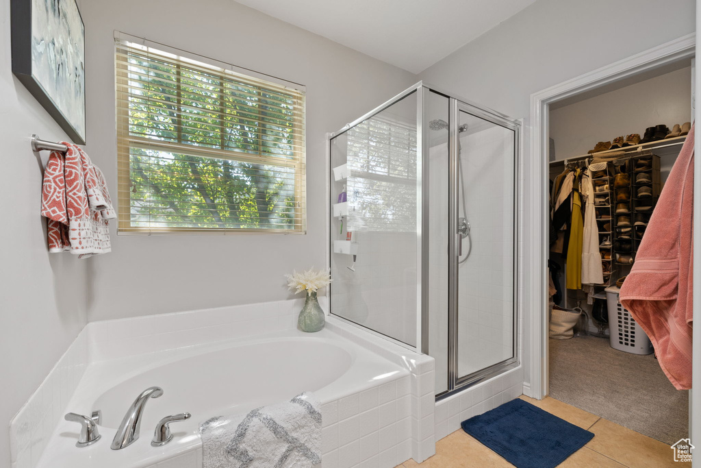 Bathroom with tile patterned flooring and independent shower and bath