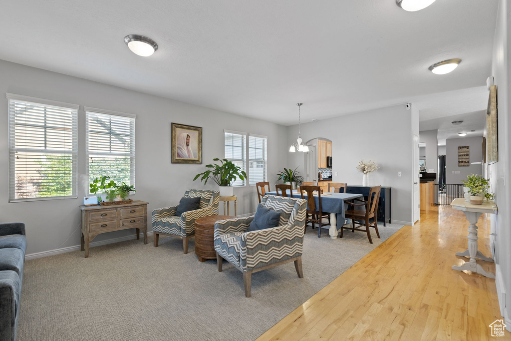 Living room featuring hardwood / wood-style floors and a chandelier