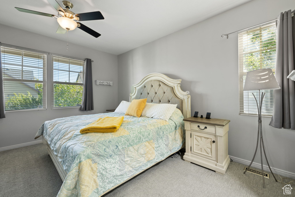 Bedroom featuring ceiling fan and carpet floors