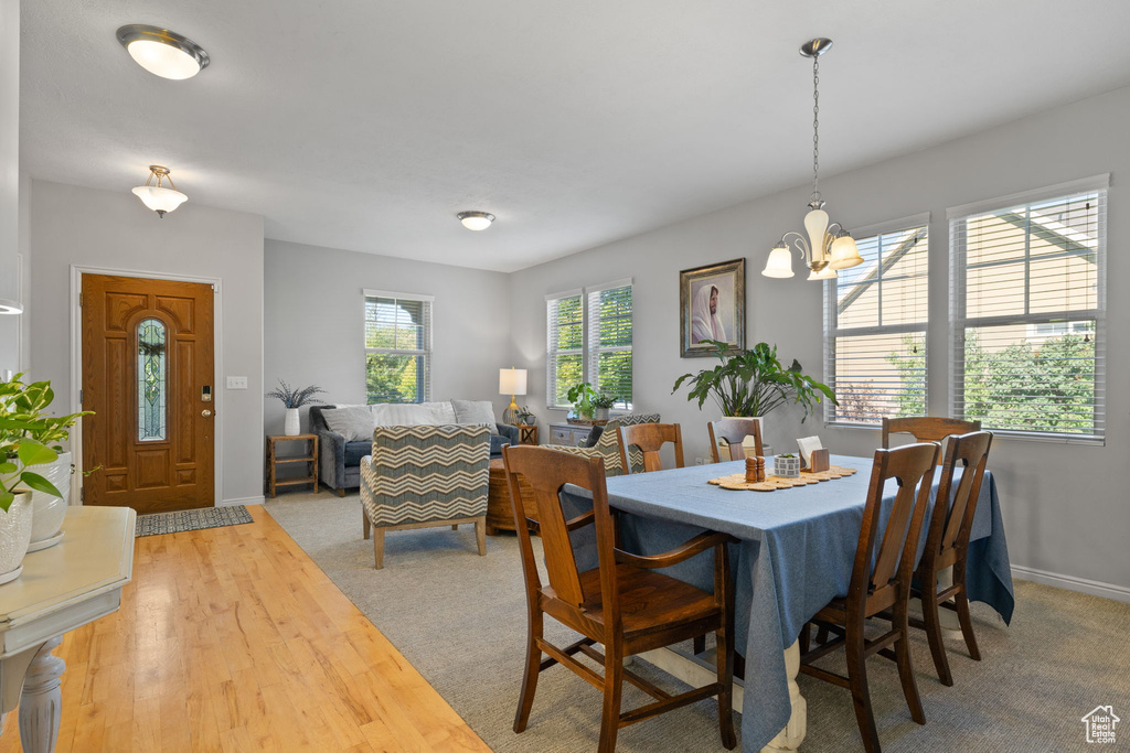 Dining room with wood-type flooring and a chandelier