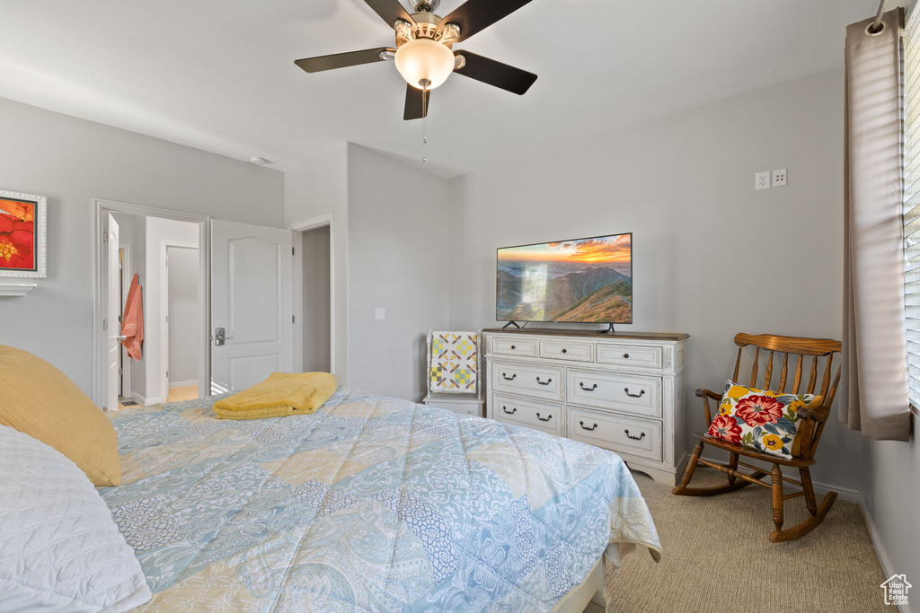 Carpeted bedroom featuring ceiling fan