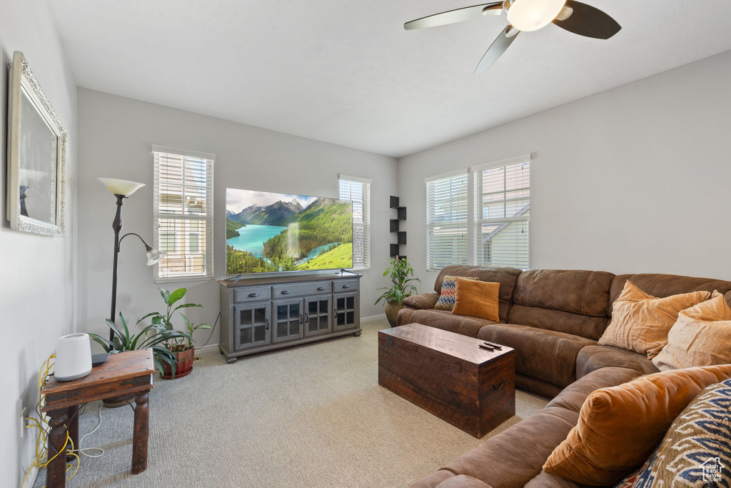 Living room featuring ceiling fan and light carpet