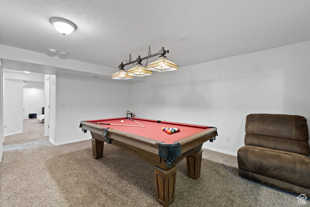 Game room with carpet floors, pool table, and a textured ceiling