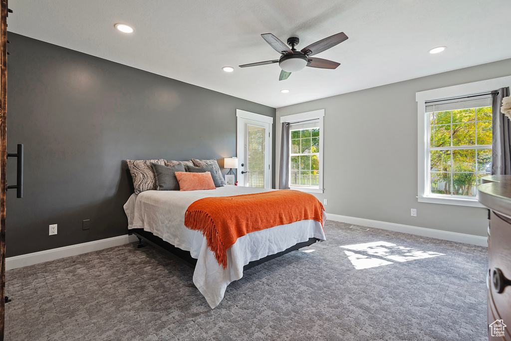 Bedroom with ceiling fan and dark carpet