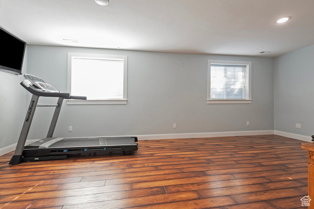 Workout area featuring dark hardwood / wood-style floors