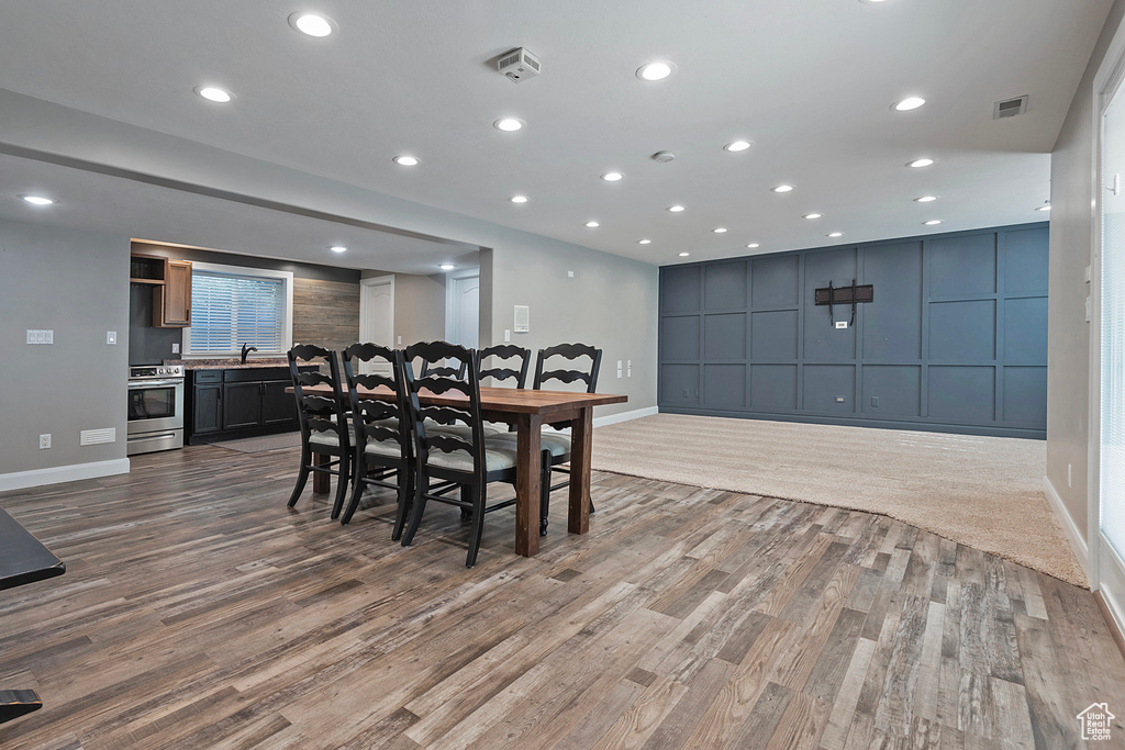 Dining space with light hardwood / wood-style floors and sink