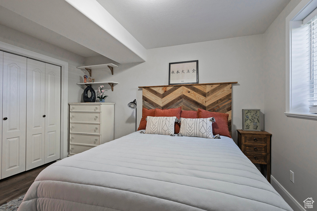 Bedroom featuring a closet and dark hardwood / wood-style flooring