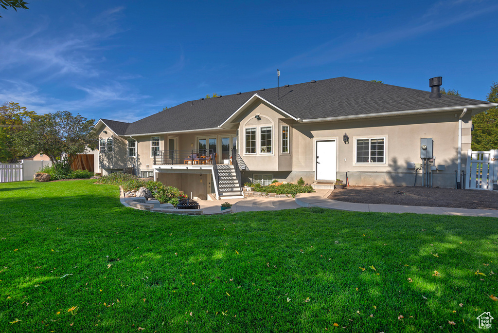 Rear view of property with a lawn